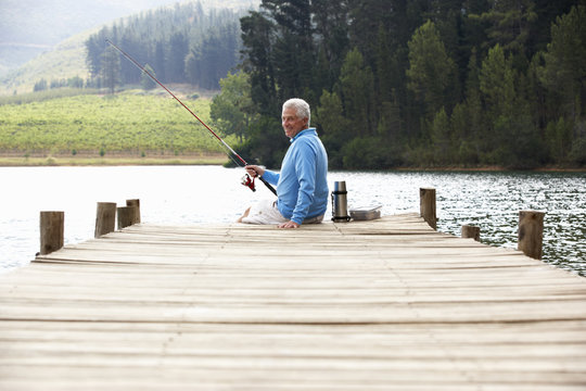 Senior Man Fishing On Jetty