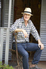 Fototapeta premium Mid age man resting on veranda
