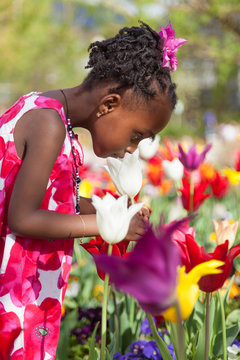 Cute little african american girl playing in the garden