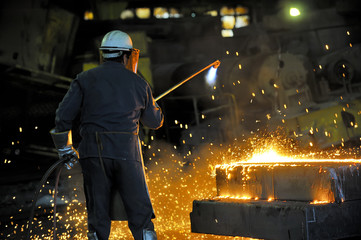 worker using torch cutter