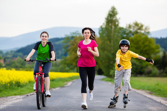 Active Family - Mother And Kids Running, Biking, Rollerblading