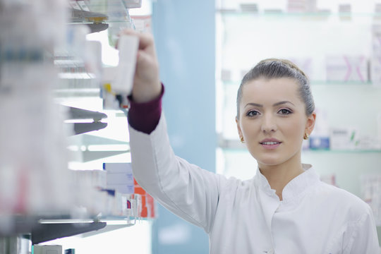 pharmacist chemist woman standing in pharmacy drugstore