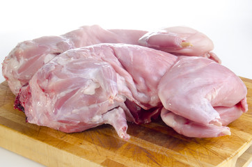 freshly slaughtered rabbit on a wooden board