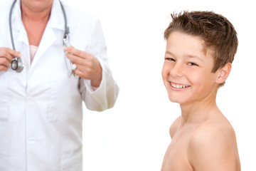 Portrait of boy with doctor in background.
