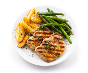 Grilled steaks, baked potatoes and vegetables