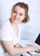 Portrait of smiling beautiful asian wonan with a laptop