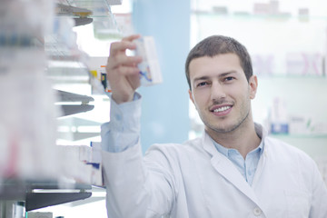 pharmacist chemist man in pharmacy drugstore