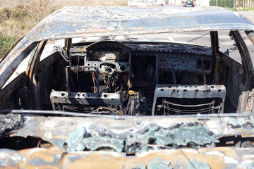 Burned out car in street