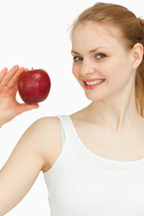 Woman holding an apple while smiling