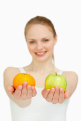 Fototapeta na wymiar Close up of a young woman presenting fruits