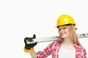 Woman smiling while holding a spirit level