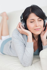 Woman closing her eyes while wearing headphones