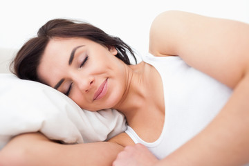 Obraz na płótnie Canvas Peaceful woman lying while sleeping in the morning