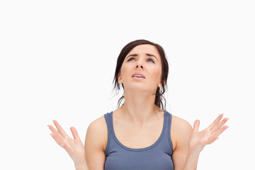 Young woman begging while looking up