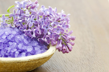 Fototapeta na wymiar bath salt and flowers of lilac