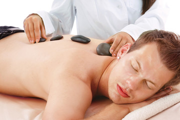 Obraz na płótnie Canvas high angle view of man receiving hot stone massage