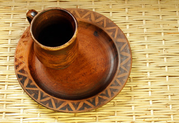 brown clay cup and plate