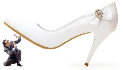 Woman domination concept with shoes and man
