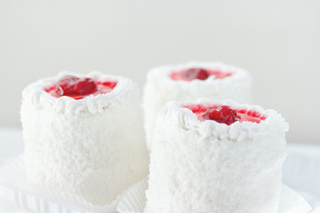 Three cream cake with cherries still life closeup