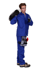 Male electrician holding wiring loom