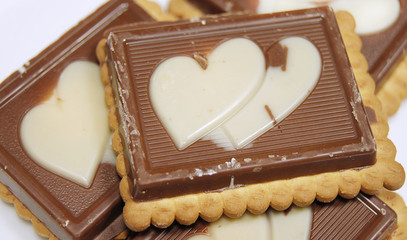Biscuit covered with chocolate and hearts on it