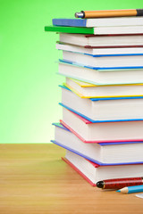 pile of books and pen on green