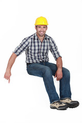 Handyman pointing downwards