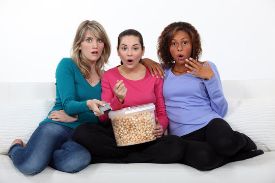 Three Women Eating Popcorn Whilst Watching Film