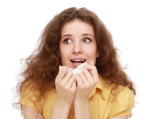 A young woman sneezing