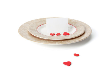 An invitation card with hearts on a plate