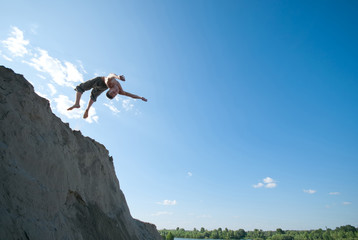 Excited young man jumping in air