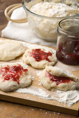 Dough with marmelade on wooden board
