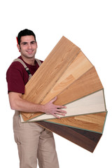 Carpenter holding plywood