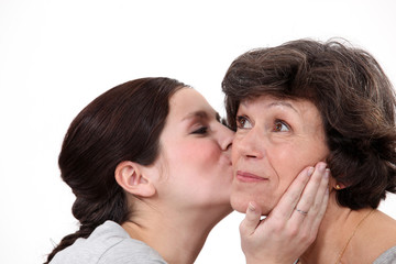 Daughter kissing mother