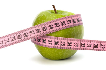 Apple with tape measure. Healthy lifestyle concept.