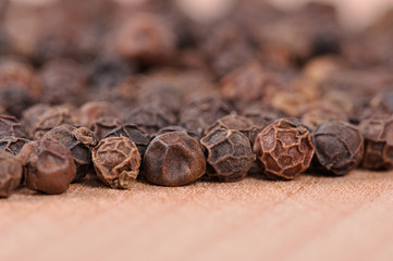 Black pepper on the wooden cutting board