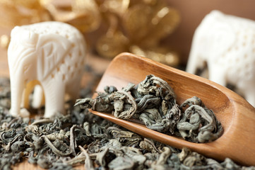 Green tea in a wooden spoon