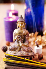 Statue of Buddha, incense and candles