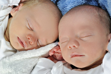 Adorable twins sleeping together
