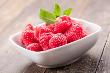 Raspberries on wooden table