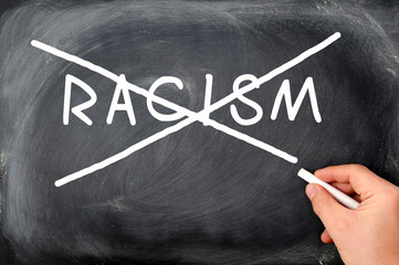 Crossing out racism on a blackboard