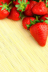 Delicious strawberries on bamboo mat background
