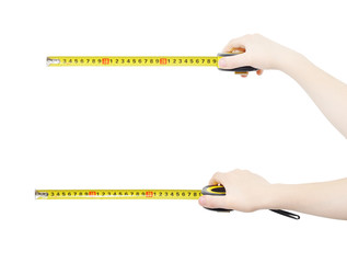 Hands holding yellow rolled rulers, isolated