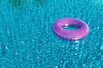 Pink flow ring in swimming pool, lazy summer holiday