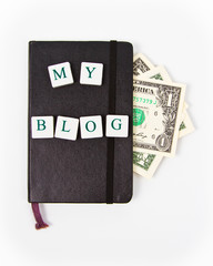 black notepad with my blog message and dollars