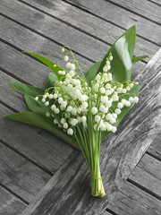 lily of the valley  on old wooden table