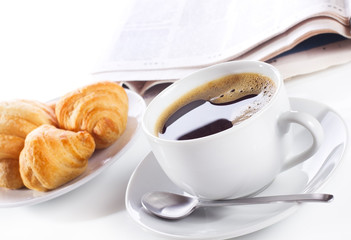 cup of black coffee, croissants and newspaper