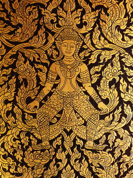 Thai golden painting on the door of ancient tripitaka building.