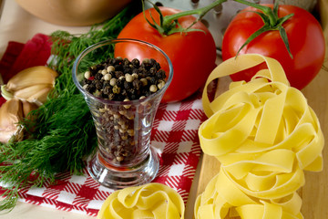 Ingredients for cooking pasta with tomatoes and herbs