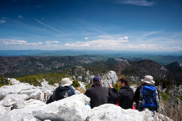 group mountaineers resting on the top of the hill